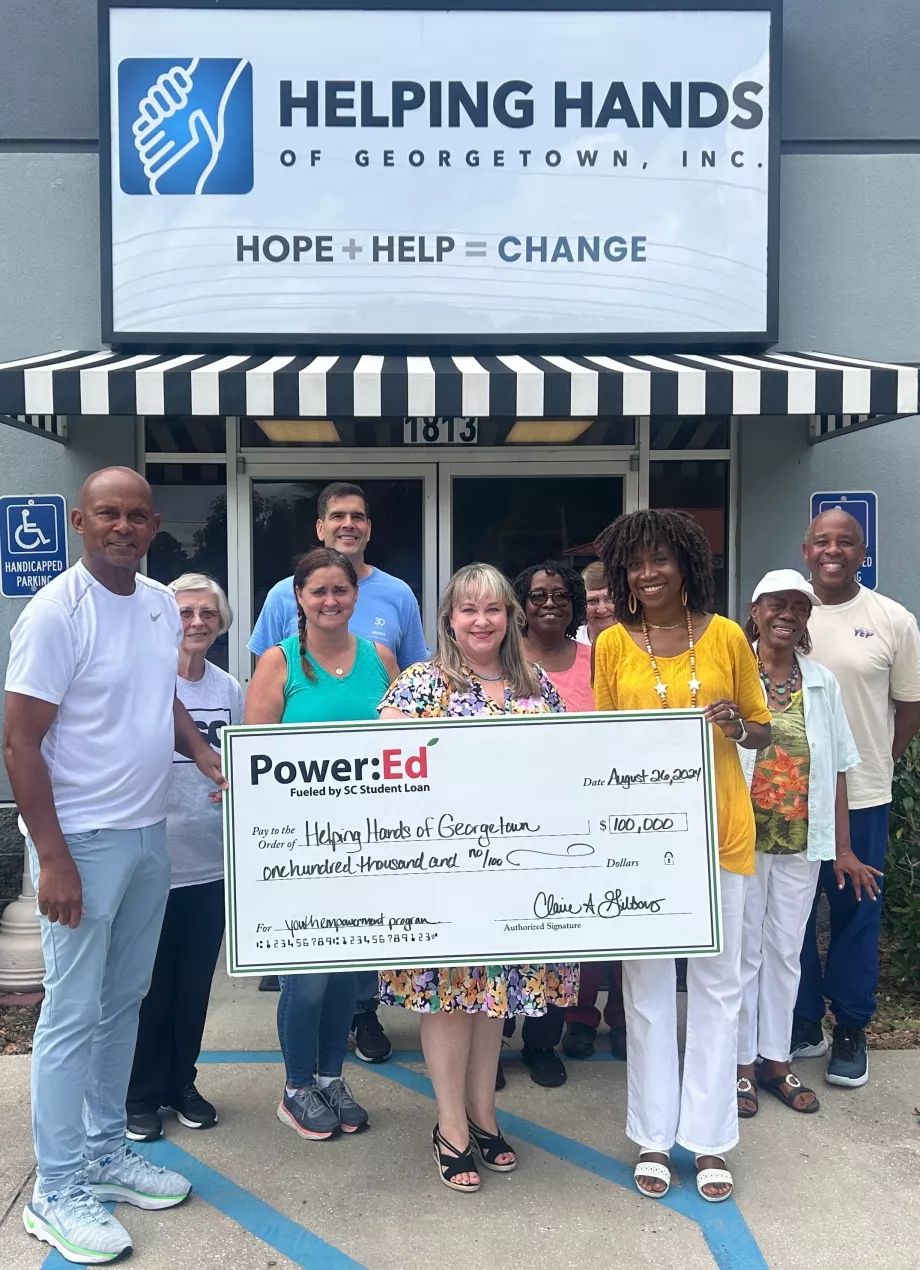 People pose with ceremonial check